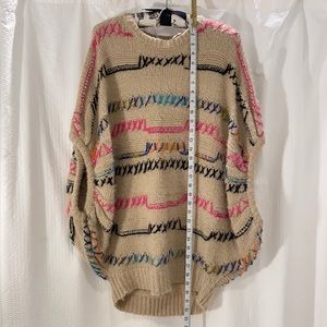 Easel size S/M multi-color yarn stitched on a cream/tan sweater